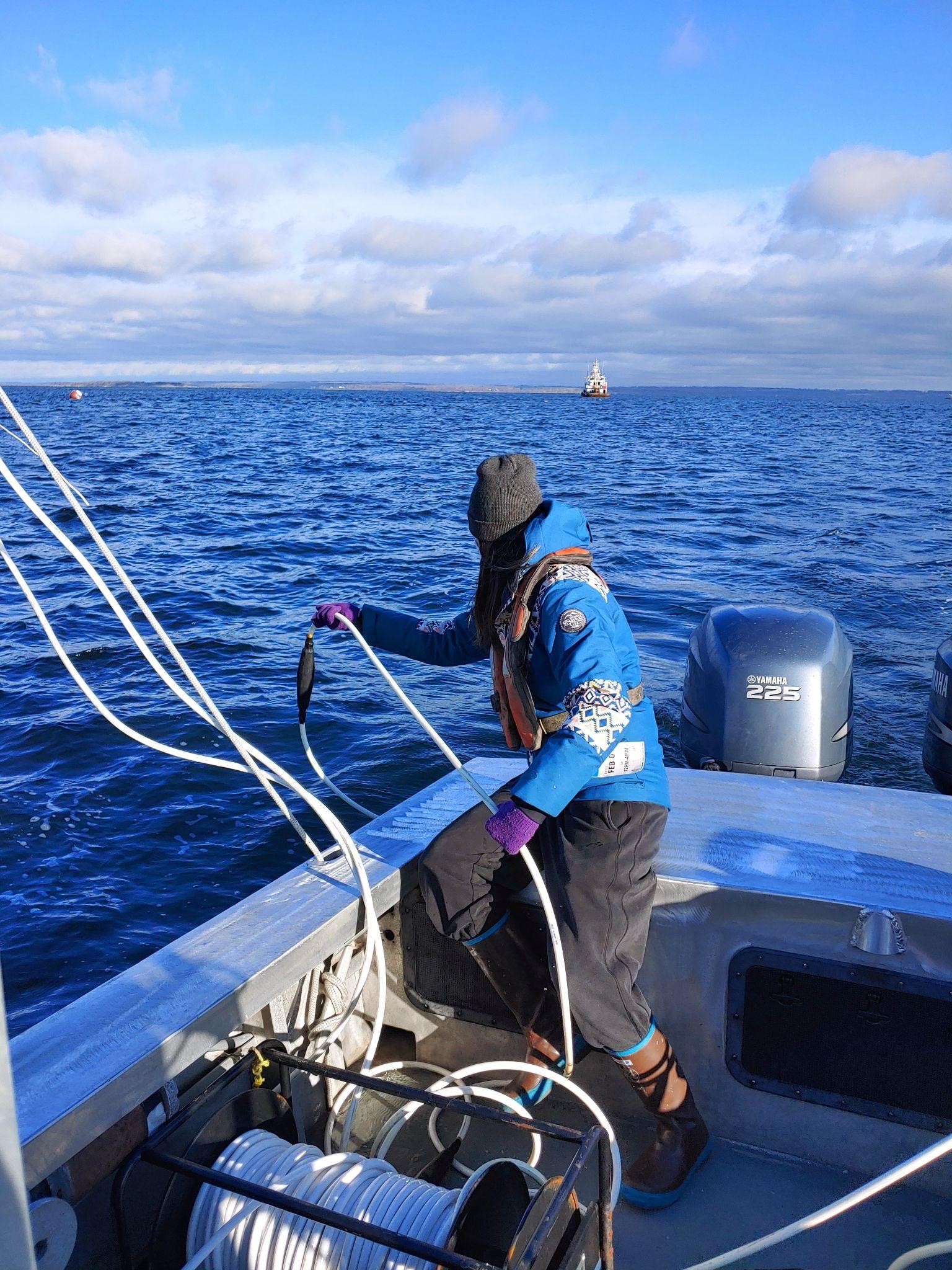 Scientist conducting marine research from a small boat